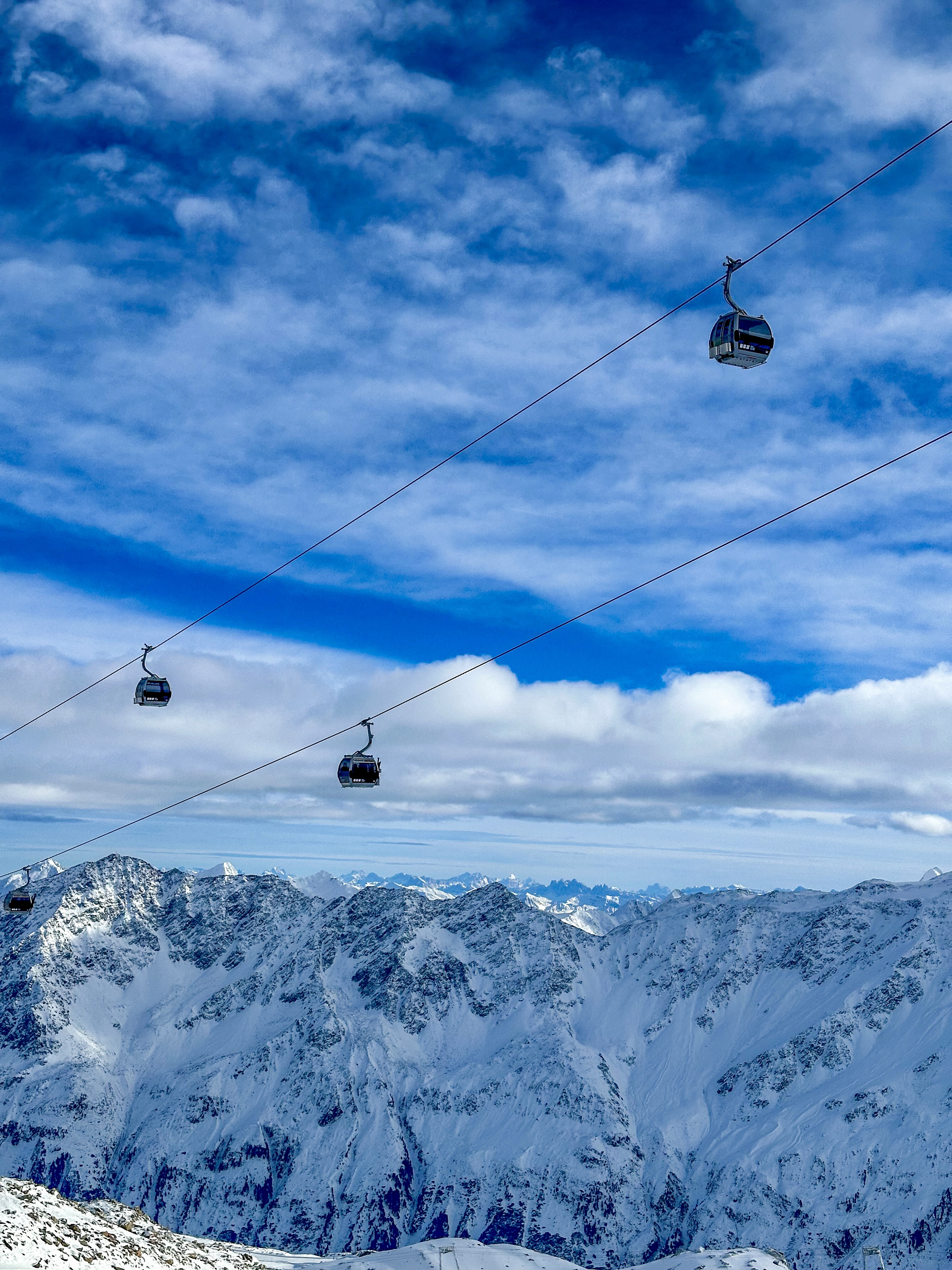 Cable cars above snowy mountains