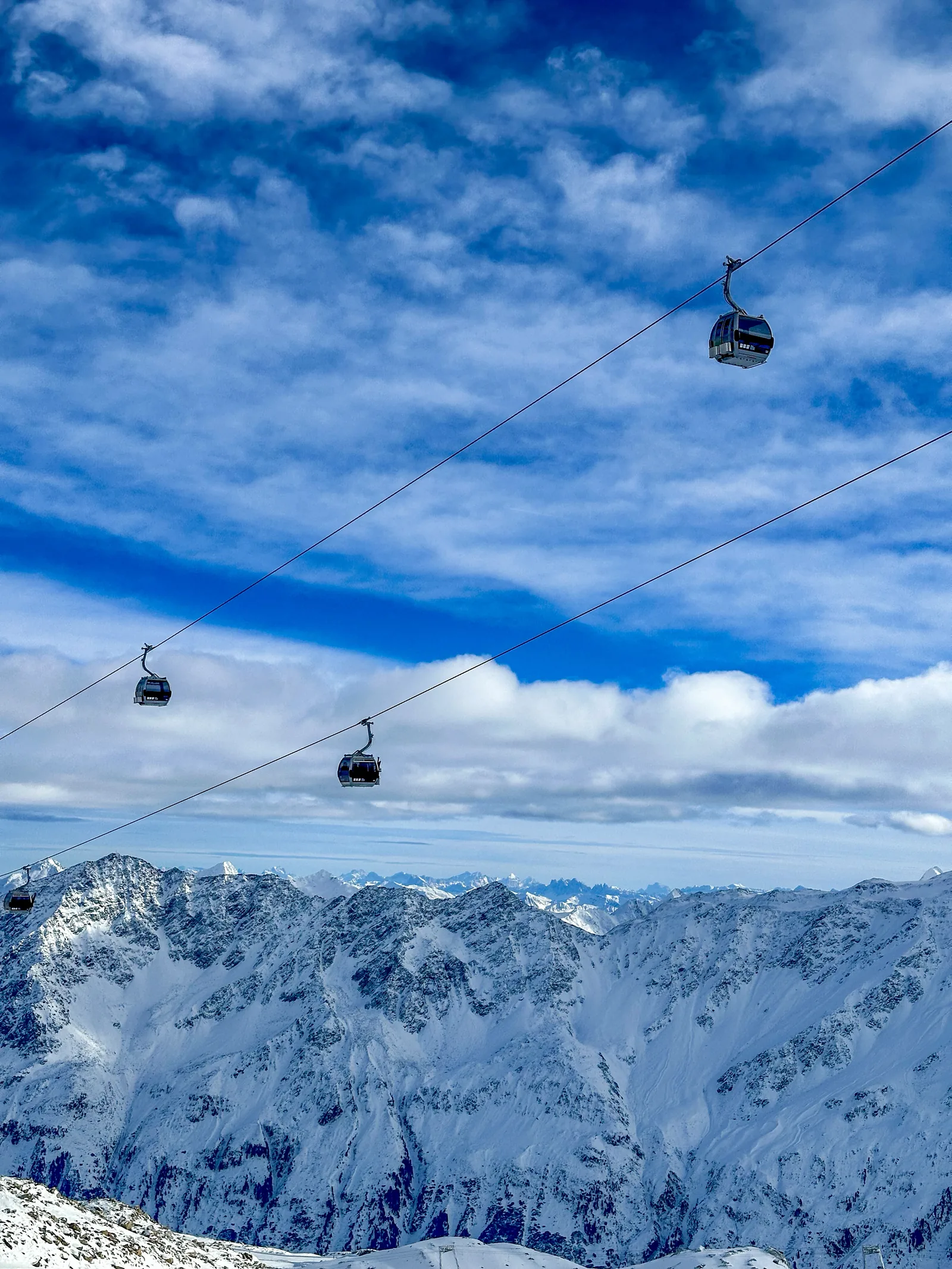 Cable cars above snowy mountains